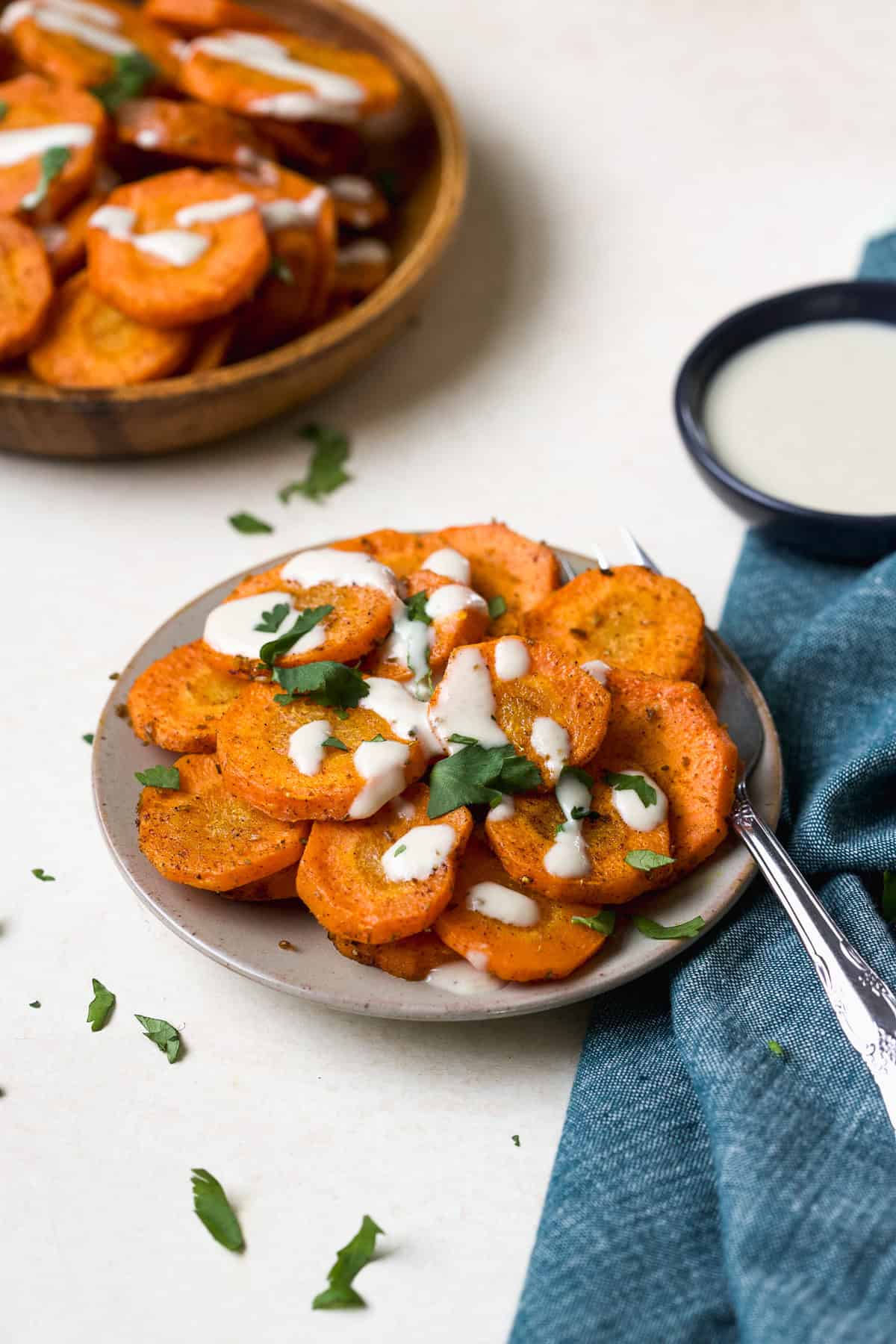 Moroccan-spiced roasted carrots with tahini sauce drizzled over the top.