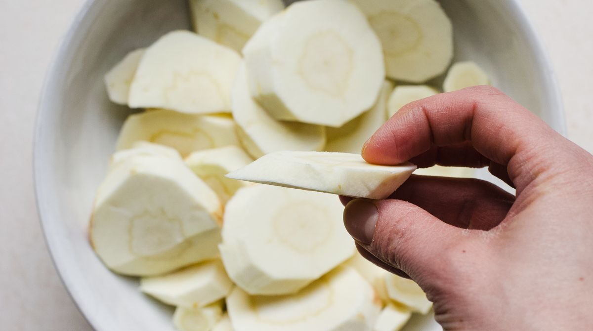 Raw parsnip sliced on the bias.