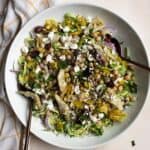 Italian Brussels sprouts chopped salad in large white serving bowl.