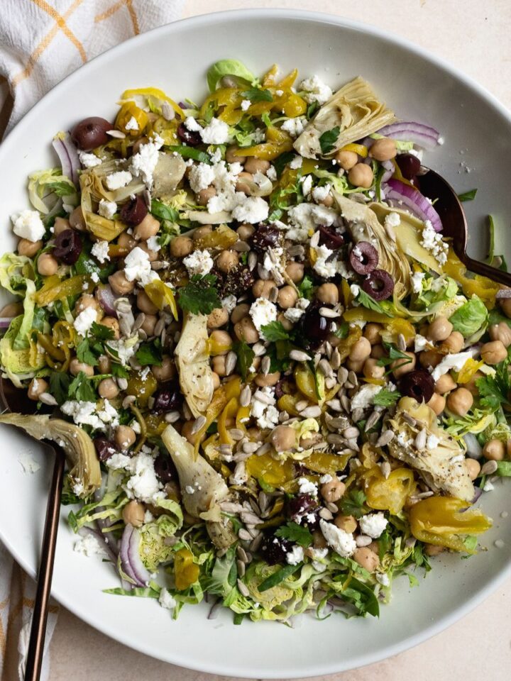 Italian Brussels sprouts chopped salad in large white serving bowl.