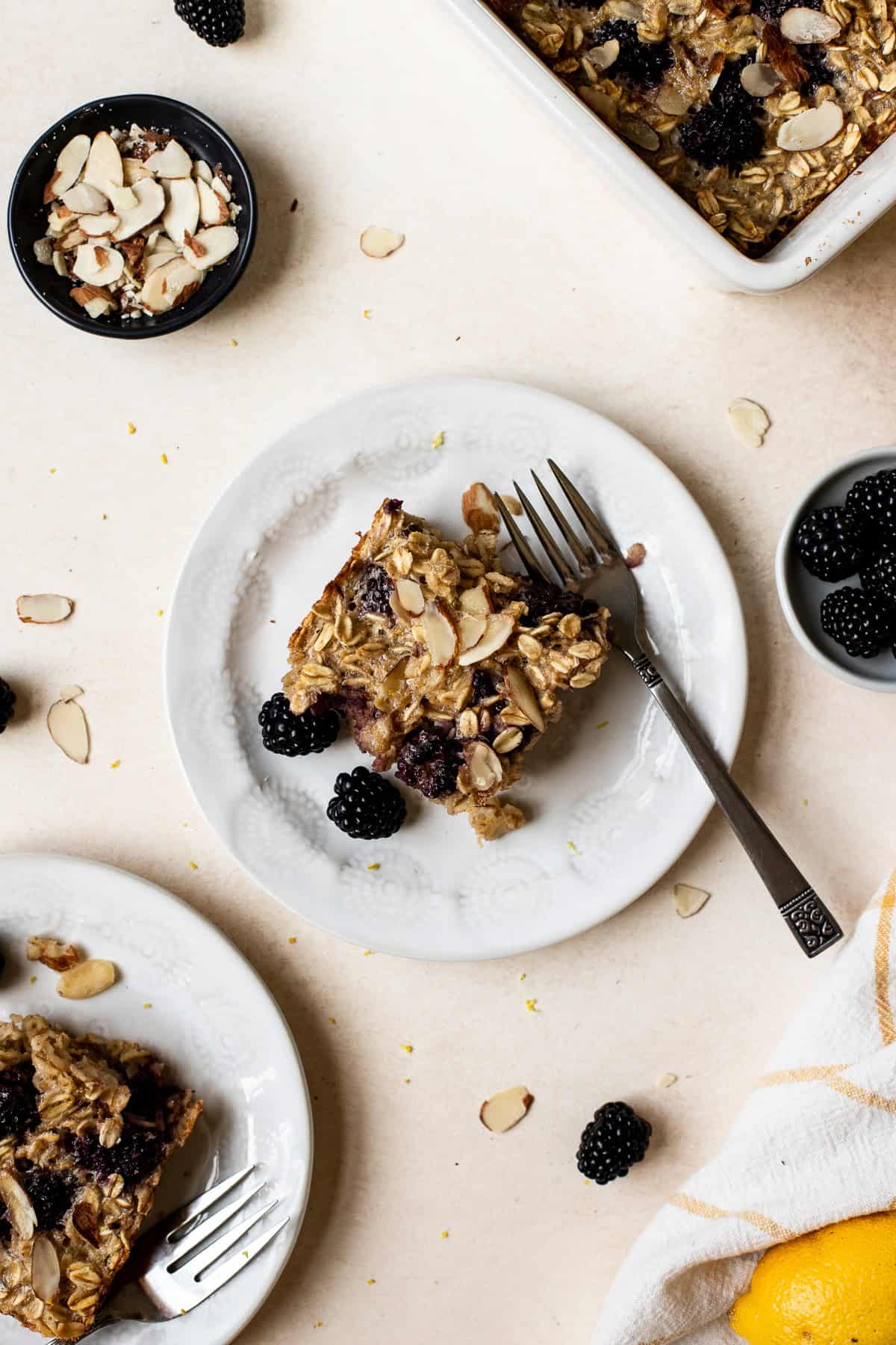 Slice of blackberry baked oatmeal on small plate with fork.