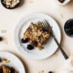 Slice of blackberry baked oatmeal on small plate with fork.