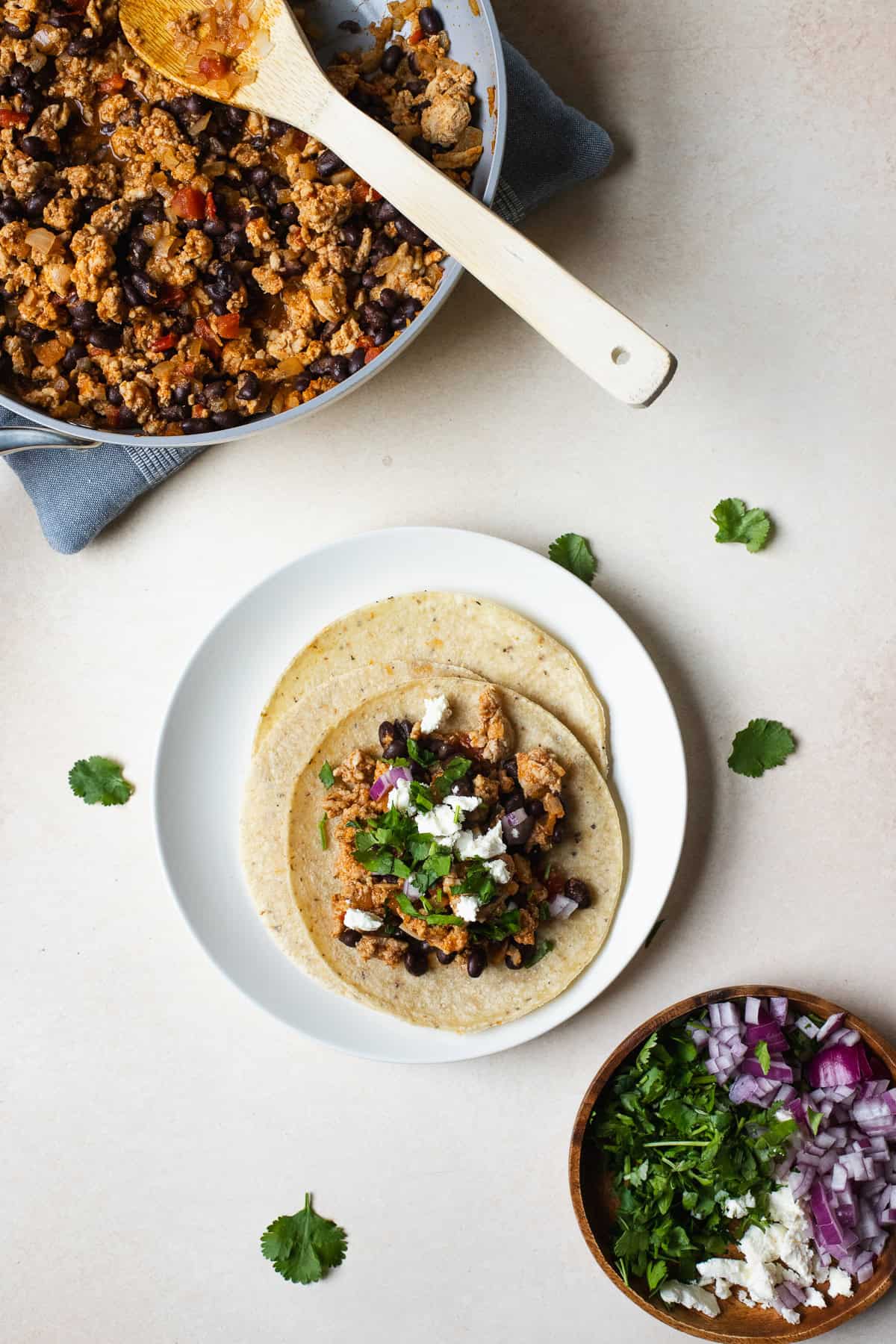 A ground chicken taco assembled on a white plate.