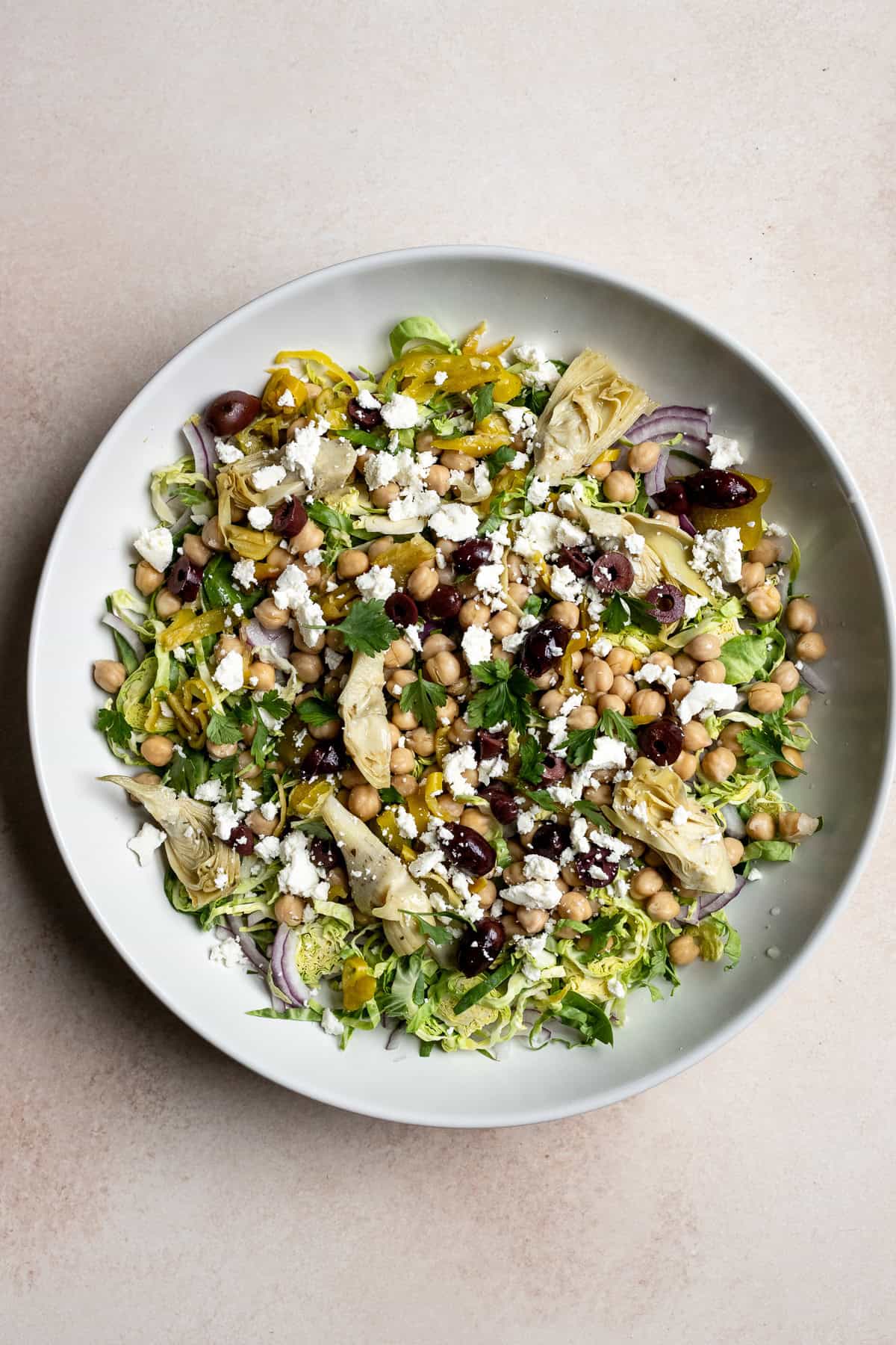 Italian Brussels sprouts chopped salad in large white serving bowl.