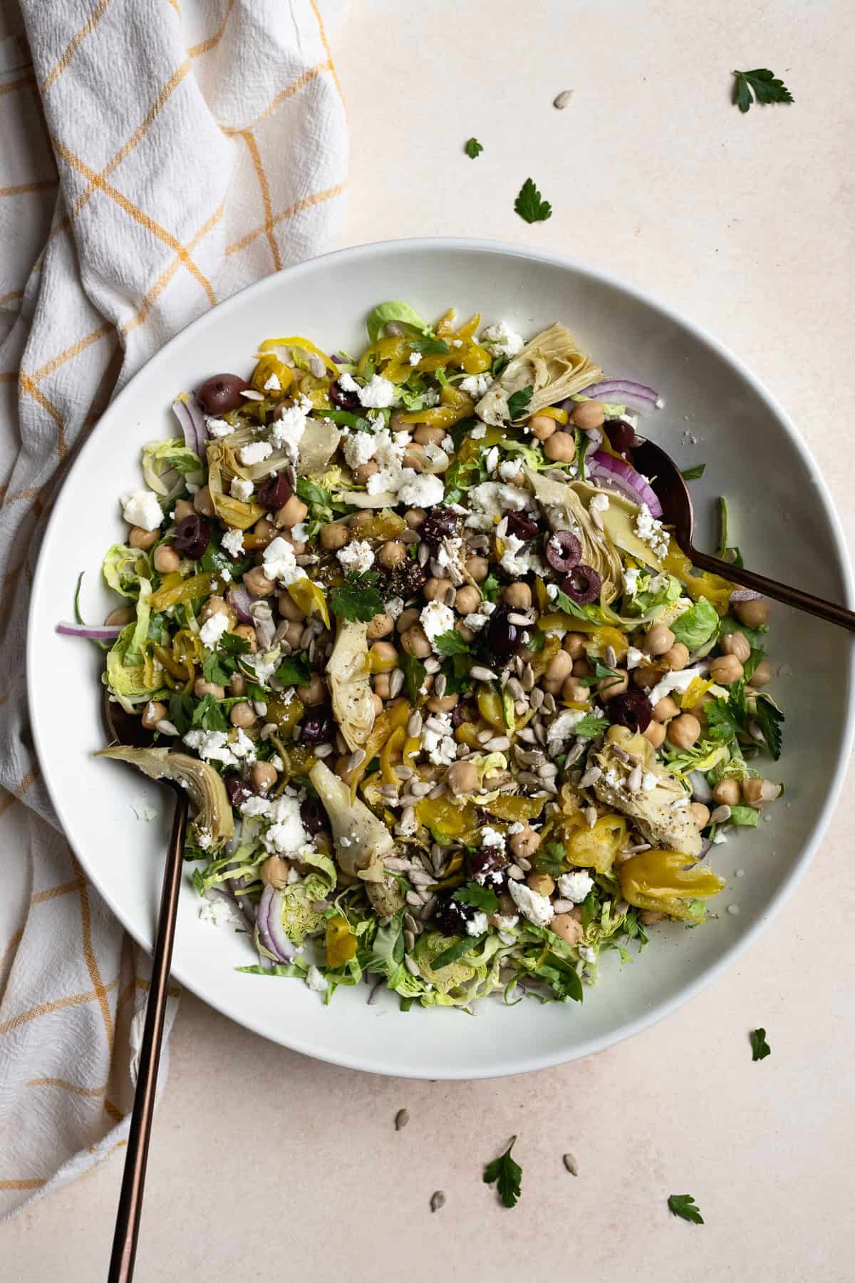Italian Brussels sprouts chopped salad in large white serving bowl.
