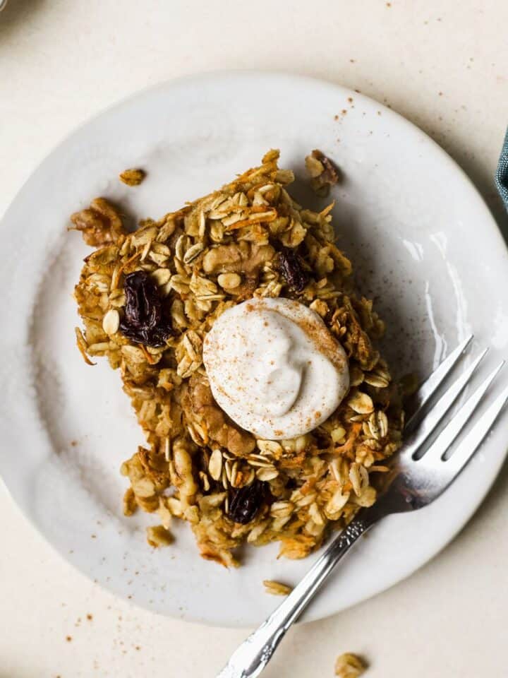 Slice of carrot cake baked oats on a plate.