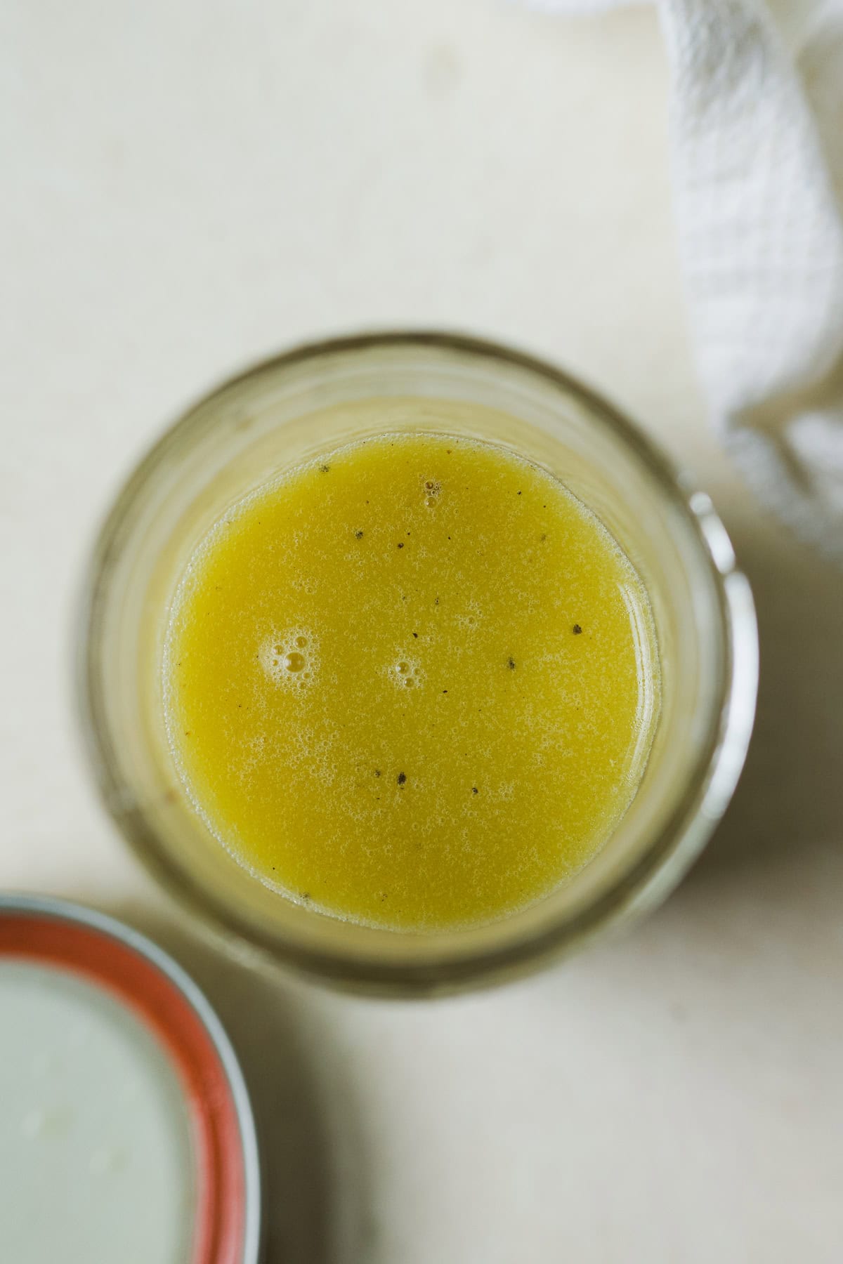 Lemon vinaigrette shaken together in a jar.