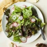 Simple leafy lettuce salad on plate.
