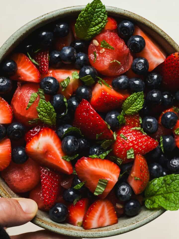 Watermelon fruit salad in a bowl with fresh mint leaves.