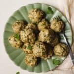 Herby baked chicken meatballs on a plate.