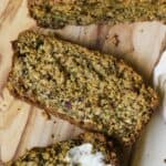 Slice of oat zucchini bread on cutting board.