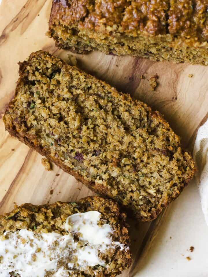 Slices of oat zucchini bread on cutting board.