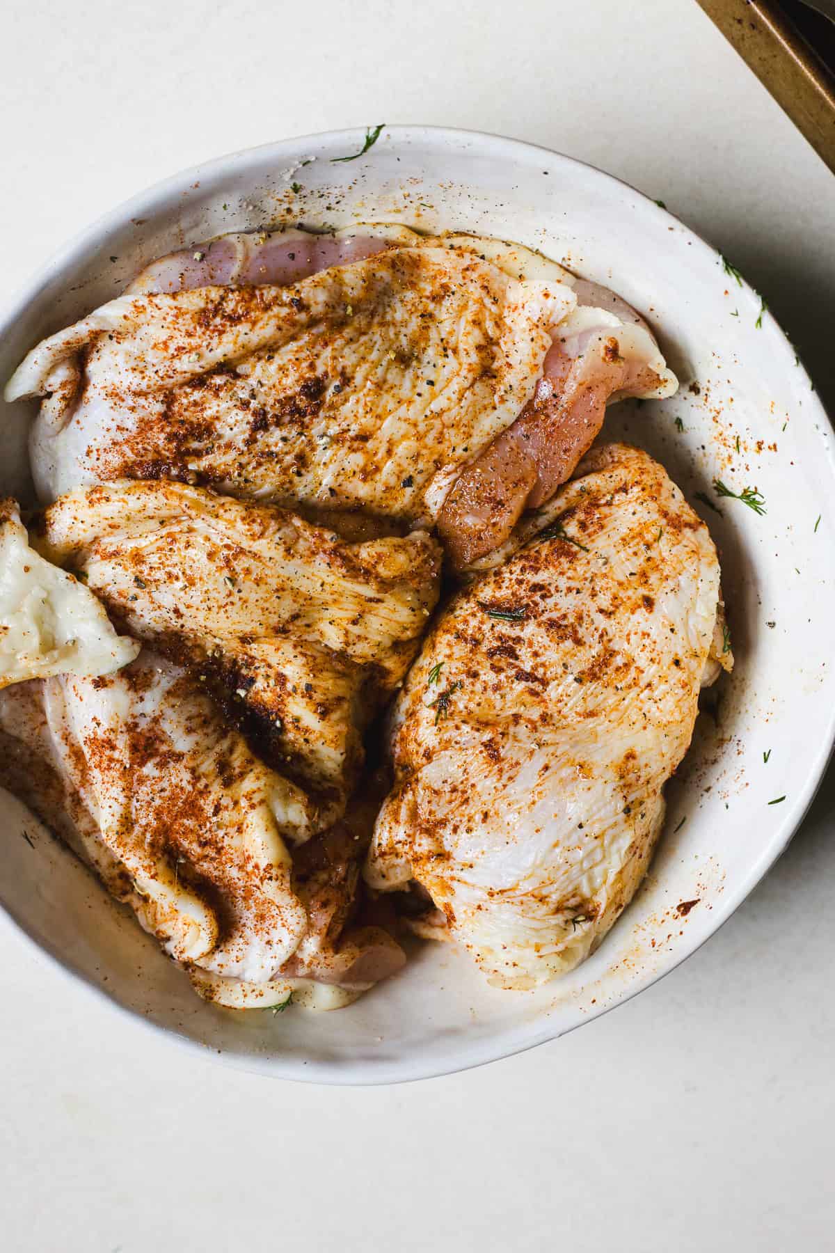 Berbere seasoned chicken thighs in a bowl.