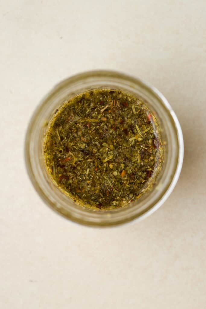 Peperoncini brine vinaigrette in a small jar.
