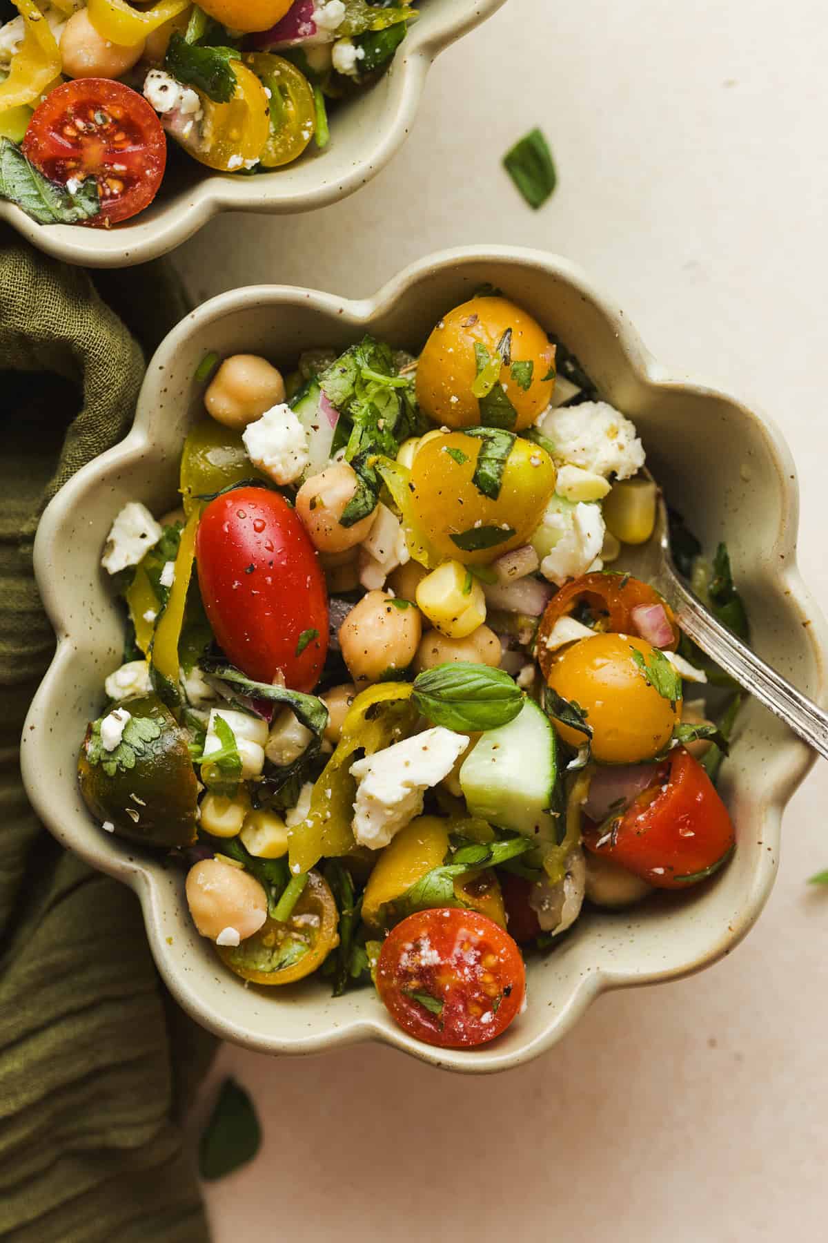 Summer chickpea salad with feta and tomatoes in a bowl.
