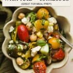 Summer chickpea salad with feta and tomatoes in a bowl.