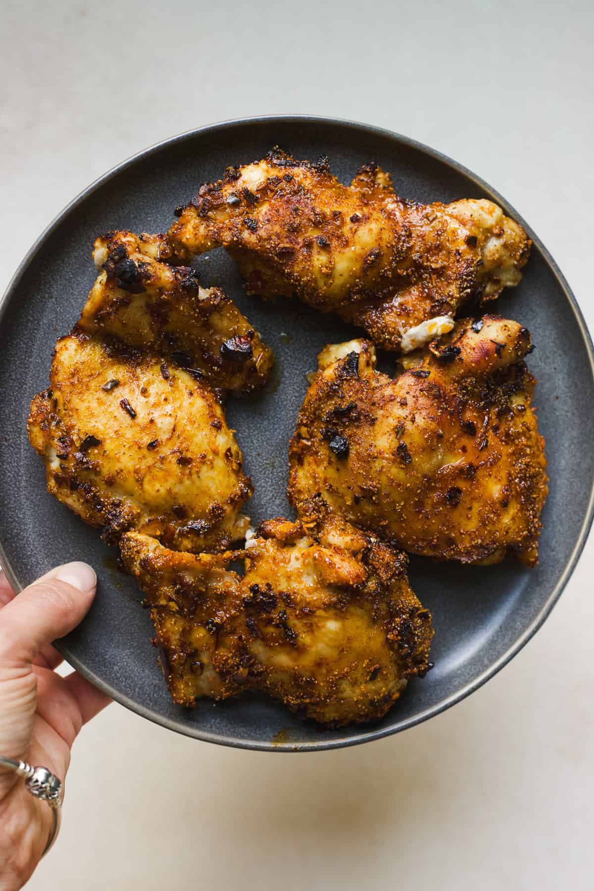 15-minute hot honey air fryer chicken thighs on a plate.