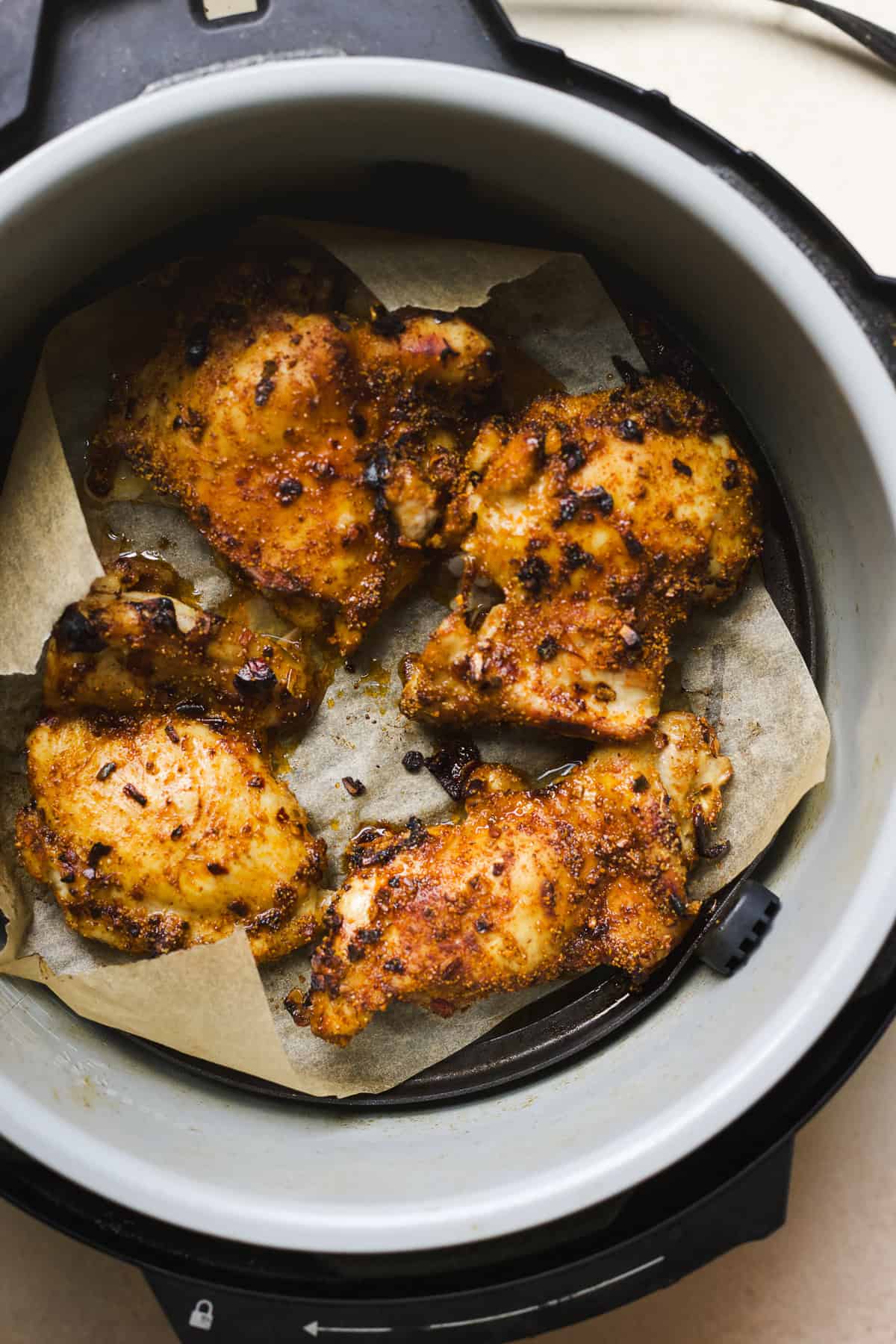 Air fryer chicken thighs with taco spices and hot honey in Ninja Foodi air fryer.