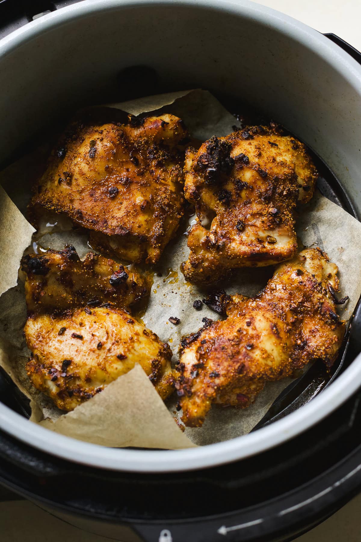 Air fryer chicken thighs with taco spices and hot honey in Ninja Foodi air fryer.