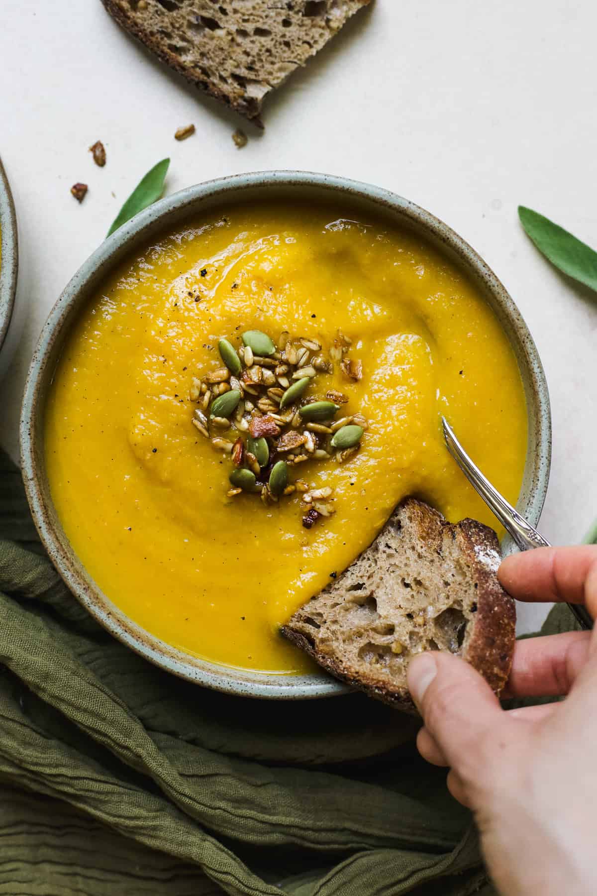 Dunking bread in a bowl of butternut squash soup with apple.
