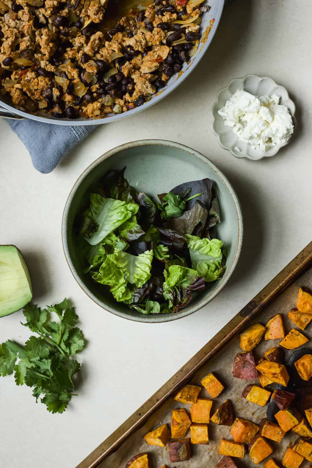 Ingredients ready to assemble ground chicken sweet potato bowls.