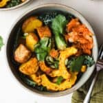 Miso curry delicata squash with tempeh in a bowl.