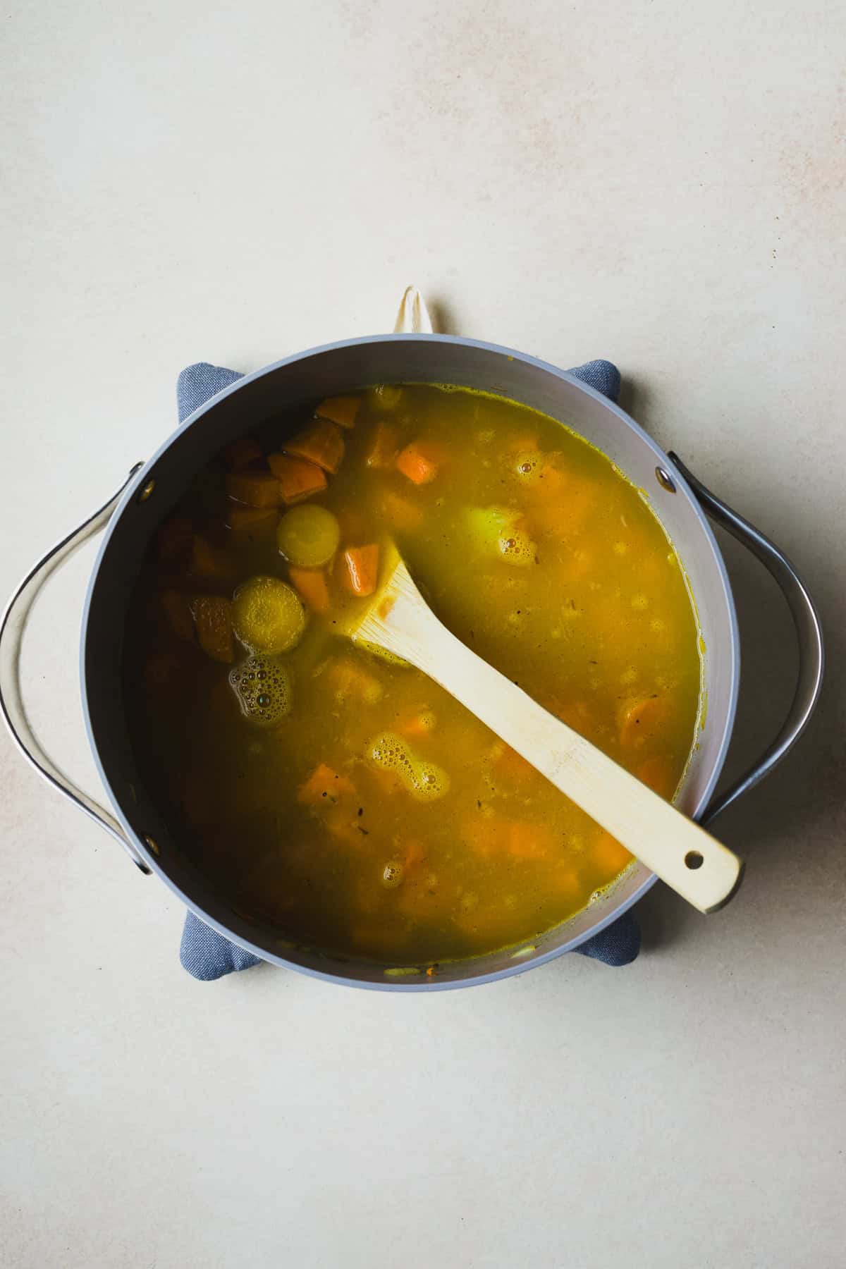 Simmering vegetables and spices for carrot and sweet potato soup.