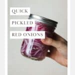 Hand shaking a jar to mix pickled red onion ingredients.