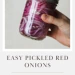 Hand shaking a jar to mix pickled red onion ingredients.