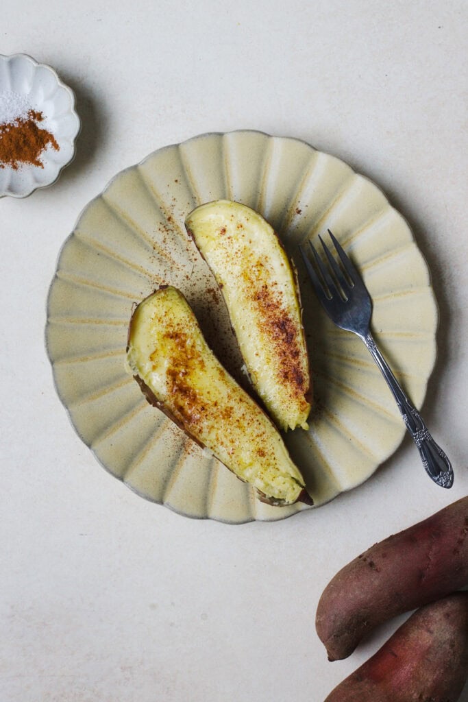 A steamed Japanese sweet potato, halved and stopped with butter and cinnamon.