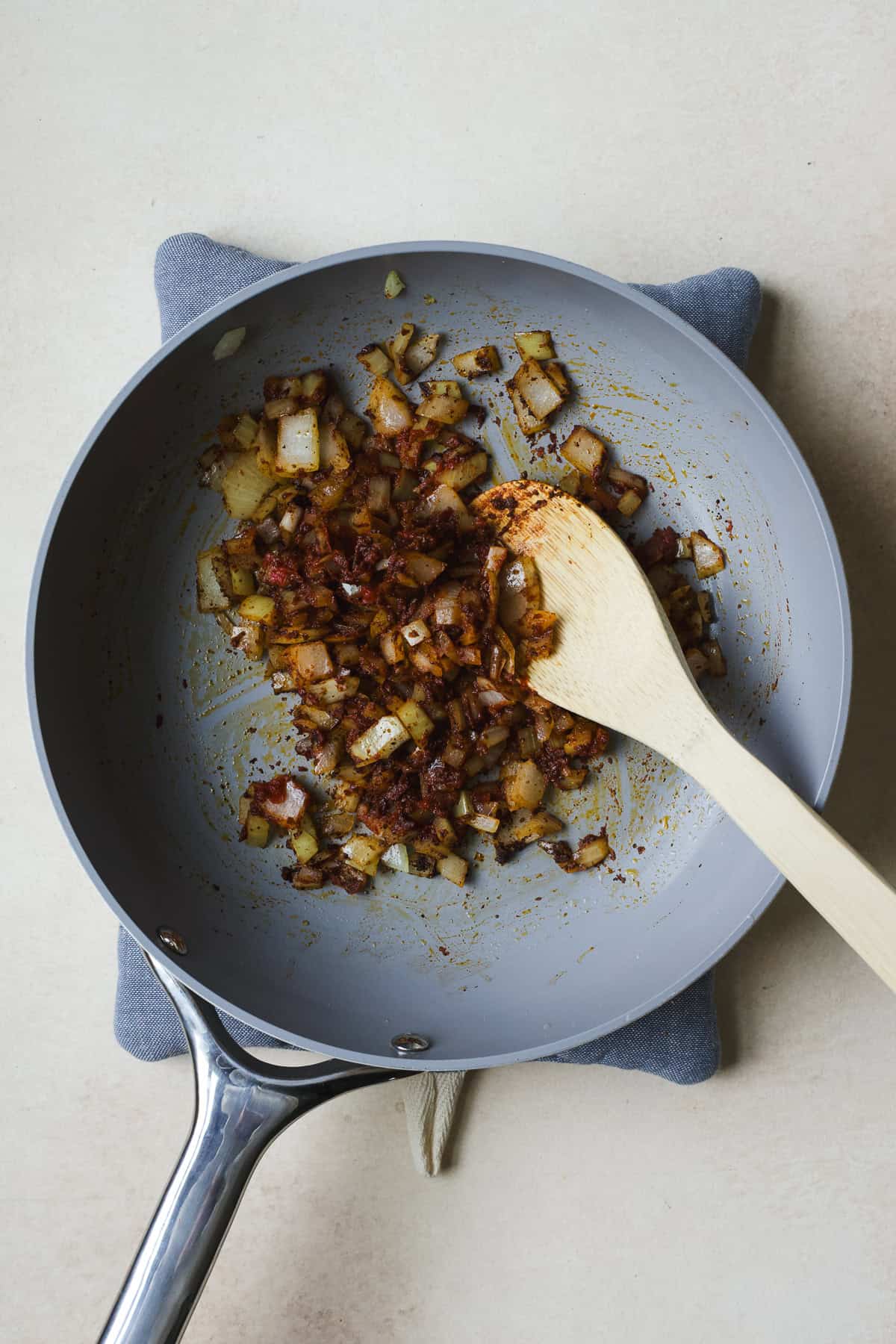 Sautéing onions with spices to make smoky black bean filling.