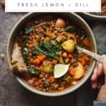 Lemony lentil soup with potatoes and fresh dill in a bowl.