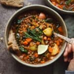 Lemony lentil soup with potatoes and fresh dill in a bowl.
