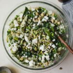 Herby orzo pasta salad with olives and chickpeas in a large bowl.