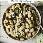 Marinated Royal Corona beans served in a bowl with a spoon.
