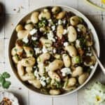 Marinated Royal Corona beans served in a bowl with a spoon.
