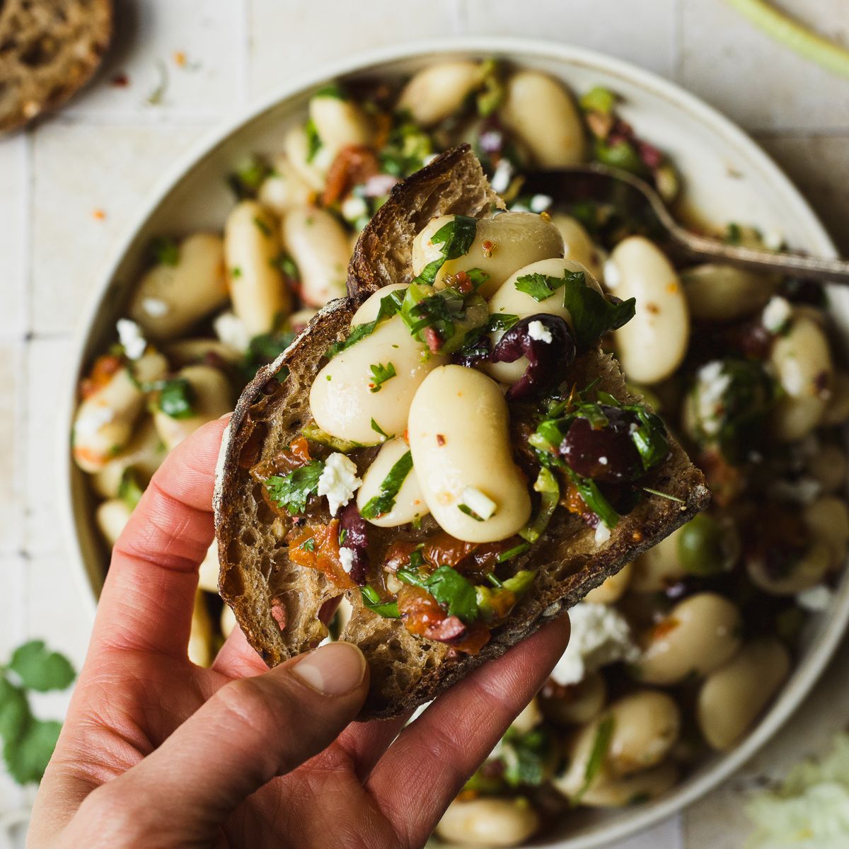 Marinated white beans on a slice of sourdough toast.