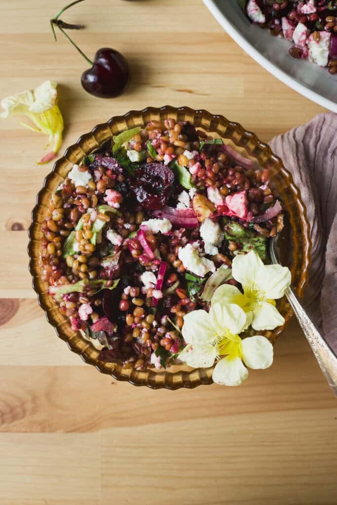 Fresh cherry salad with wheat berries in a bowl.