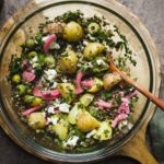 Warm lentil salad with feta and potatoes in a large bowl.