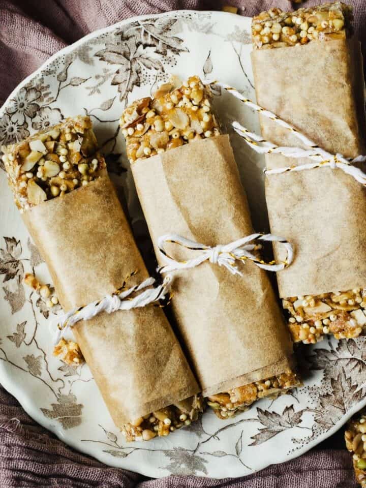 Kitchen sink homemade granola bars on a small plate on a linen, in a wooden tray.