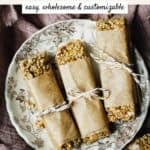 Kitchen sink homemade granola bars on a small plate on a linen, in a wooden tray.