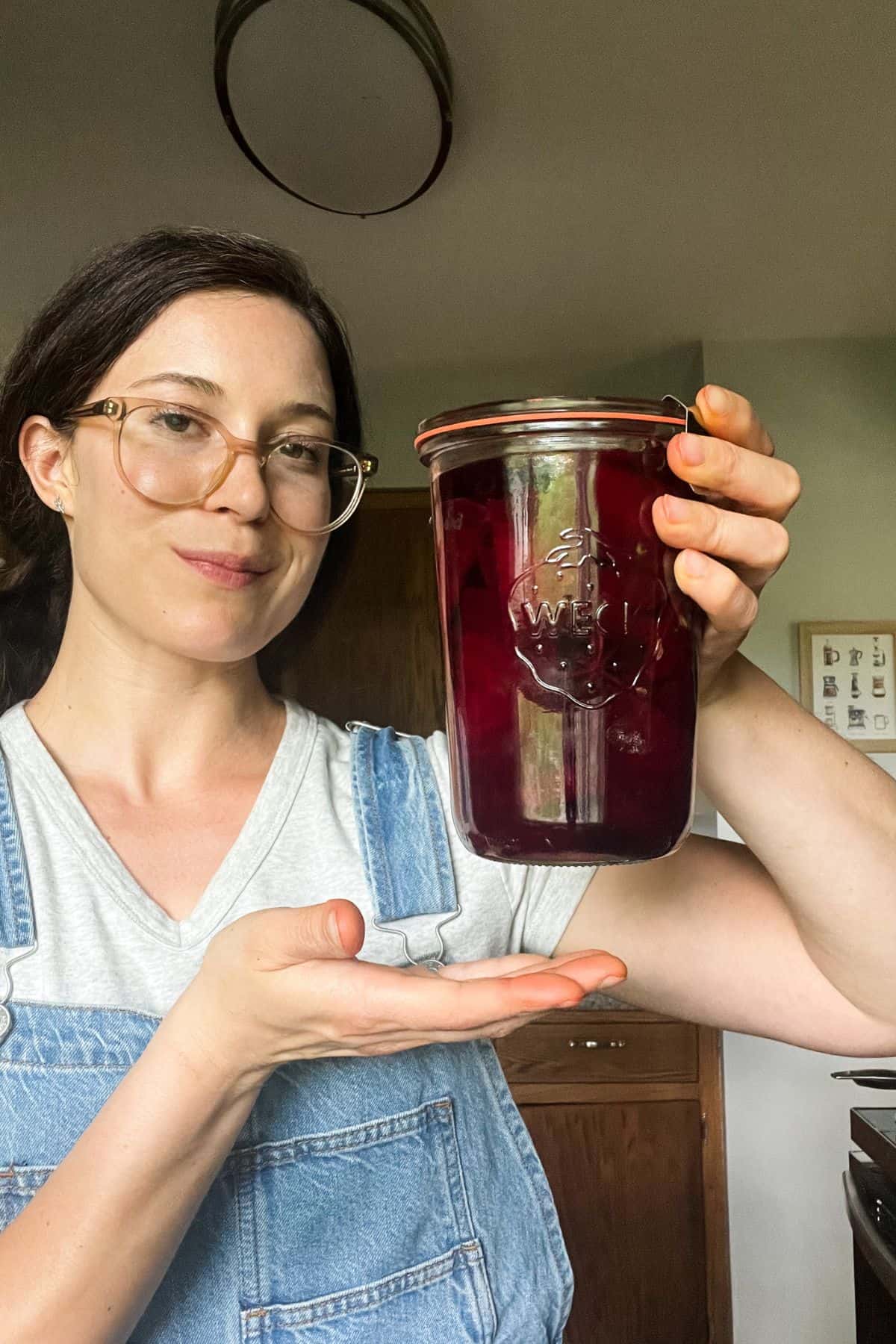 Tera holding up jar of pickled beets.