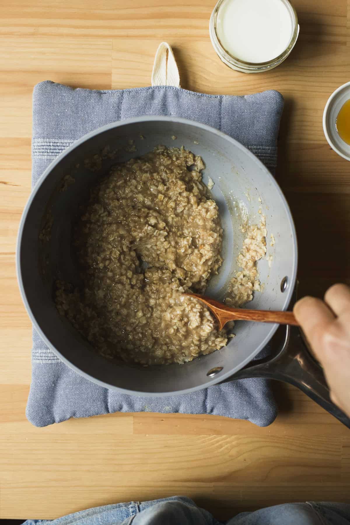Quick oats simmering with chai spices in a pot.