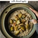 Chai oatmeal in a bowl with stewed apples, walnuts, and pepitas on top.