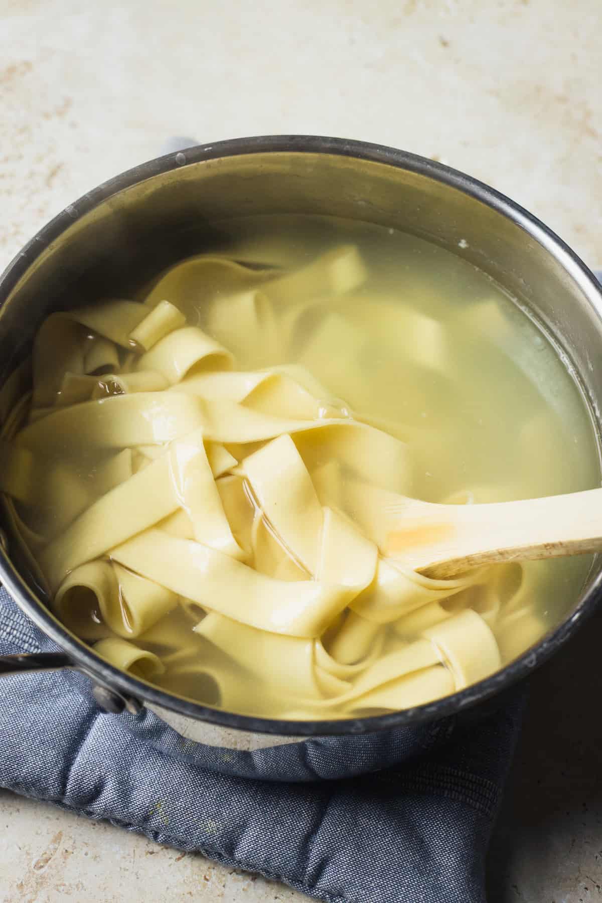 Pappardelle in a pot of water.