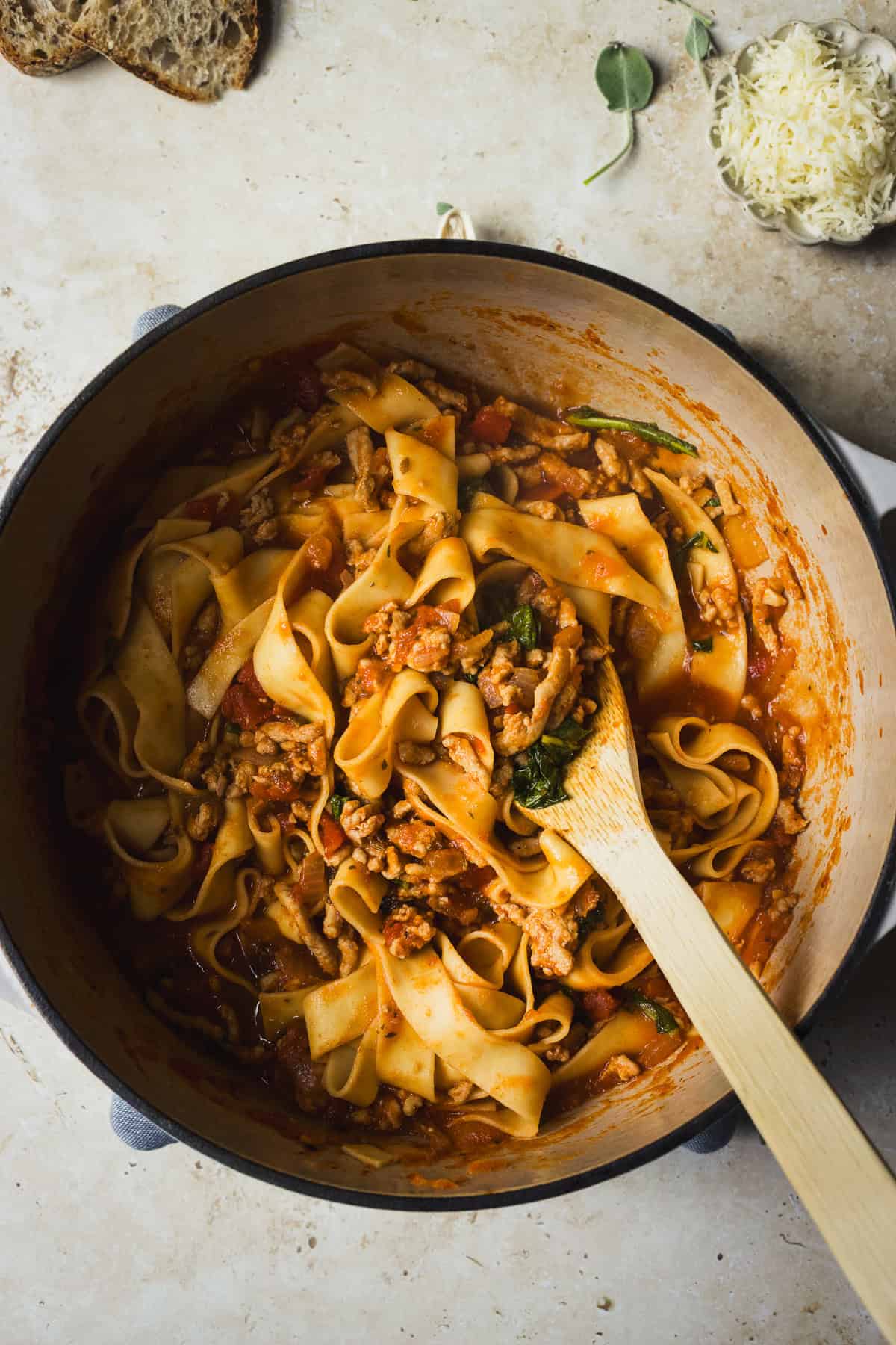 Pappardelle with ground chicken meat sauce in a dutch oven.